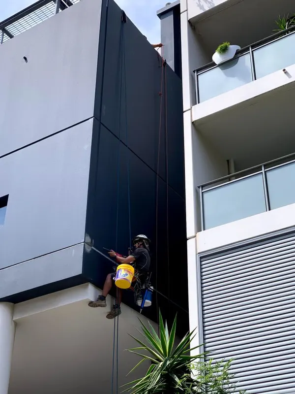 Abseiling facade repairs on an Erskineville apartment building
