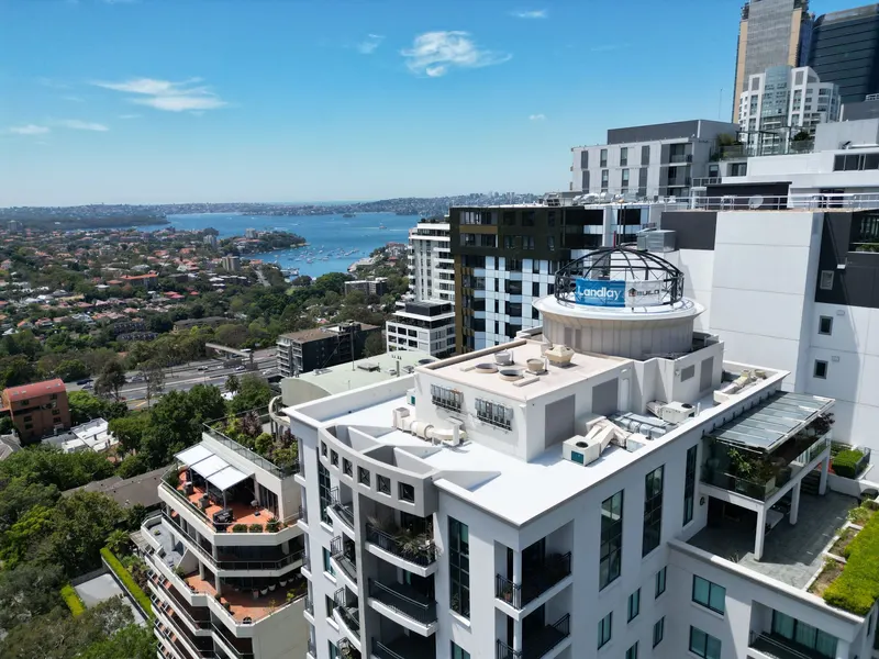 North Sydney high-rise rooftop after re-waterproofing, harbour behind