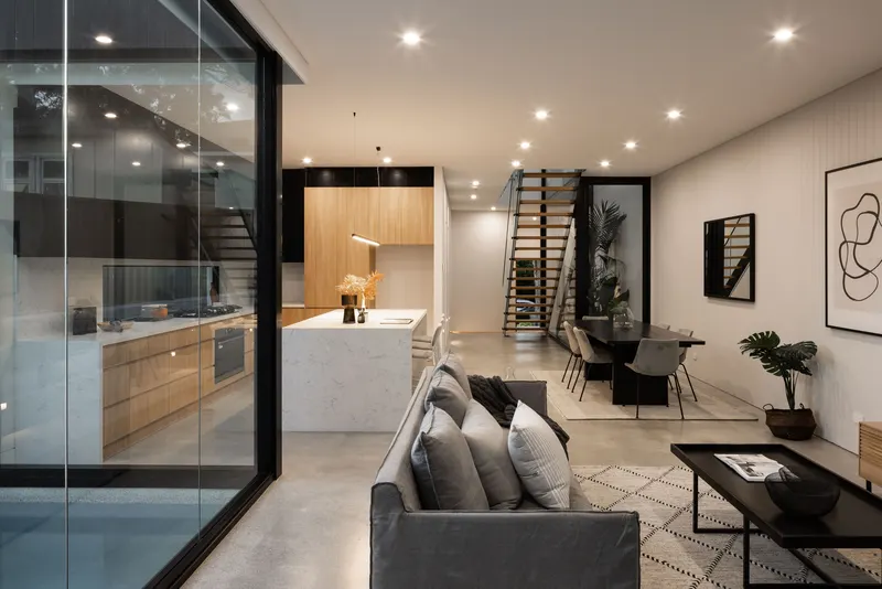 Open-plan living and kitchen with polished concrete floor, Gymea duplex