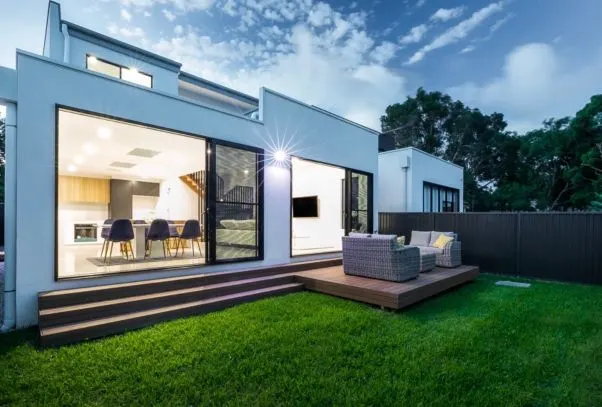 Rear of the Kirrawee dual occupancy with timber deck, lawn and open living